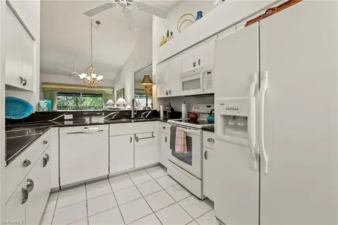 a kitchen with cabinets and appliances