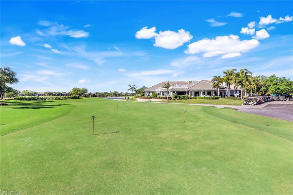 9300 Highland Woods Boulevard, Unit 3307 Bonita Springs, FL 34135 - Photo 35 of 43 a view of a golf course with a lake