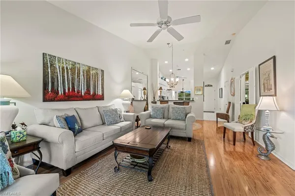 a living room with furniture or couch and a chandelier