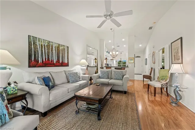 a living room with furniture or couch and a chandelier