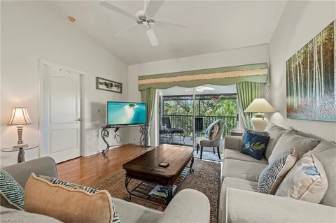 a living room with furniture and a lamp