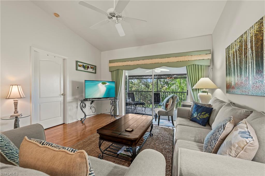 9300 Highland Woods Boulevard, Unit 3307 Bonita Springs, FL 34135 - Photo 9 of 43 a living room with furniture and a lamp