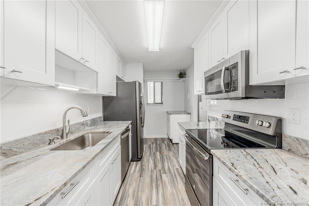 5413 Southeast Miles Grant Road, Unit G208 Stuart, FL 34997 - Photo 7 of 36 Lovely kitchen with soft close cabinetry and quartz countertops