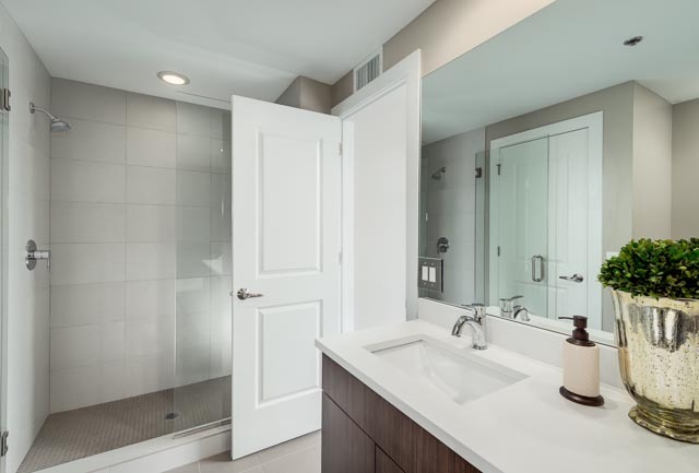 720 West Randolph Street, Unit PH7 Chicago, IL 60661 - Photo 12 of 18 a bathroom with a double vanity sink and mirror
