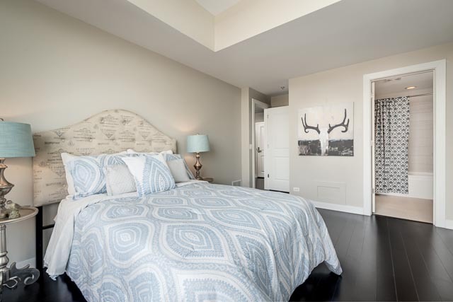 720 West Randolph Street, Unit PH7 Chicago, IL 60661 - Photo 14 of 18 a bedroom with a large bed and a wooden floor