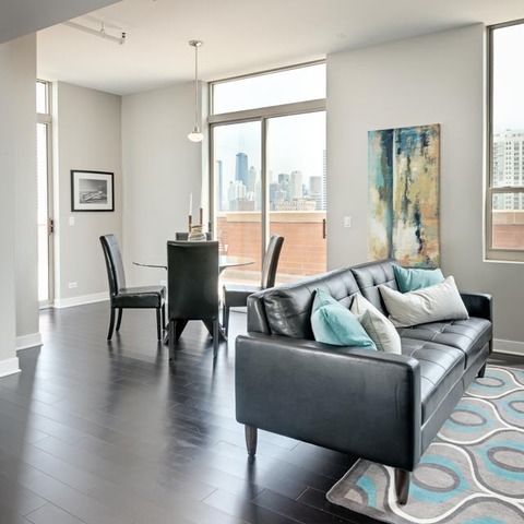 720 West Randolph Street, Unit PH7 Chicago, IL 60661 - Photo 3 of 18 a living room with furniture and a large window