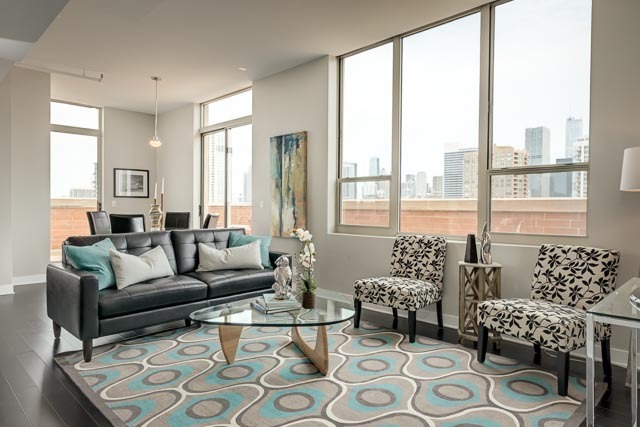720 West Randolph Street, Unit PH7 Chicago, IL 60661 - Photo 5 of 18 a living room with furniture and a large window