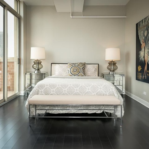 720 West Randolph Street, Unit PH7 Chicago, IL 60661 - Photo 8 of 18 a large bed sitting in a bedroom next to a window