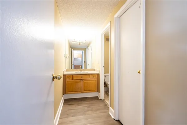 a bathroom with a granite countertop sink mirror and a toilet