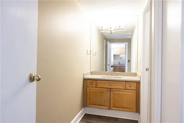 a bathroom with a granite countertop sink and a mirror