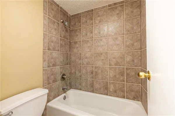 a bath tub sitting next to a white toilet