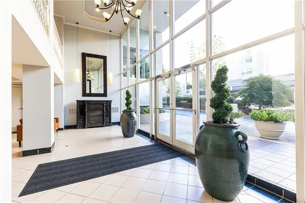 a living room with fireplace furniture and a floor to ceiling window
