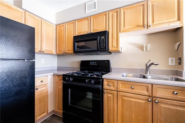 a kitchen with a stove microwave and sink