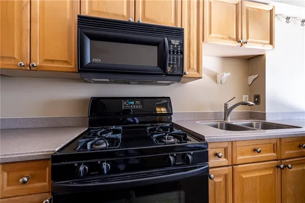 a stove top oven sitting inside of a kitchen