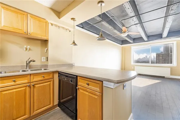 a kitchen with stainless steel appliances a stove a sink and cabinets