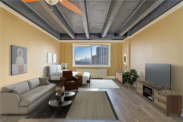 a living room with furniture flat screen tv and a large window