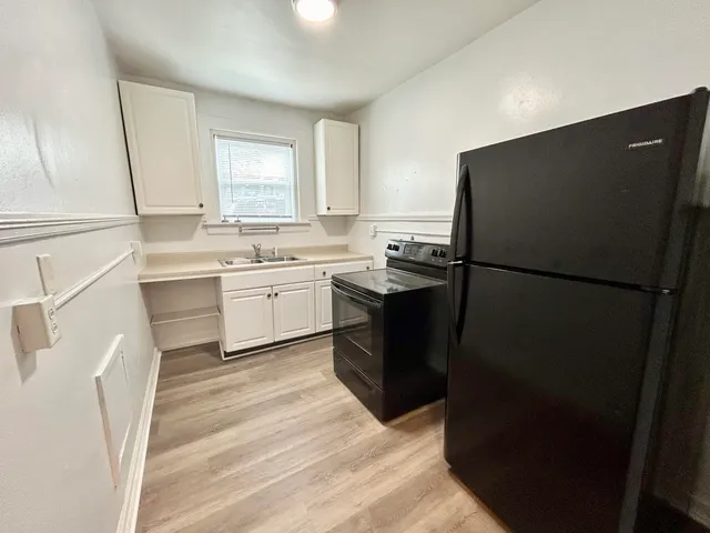 a kitchen with a sink appliances and cabinets