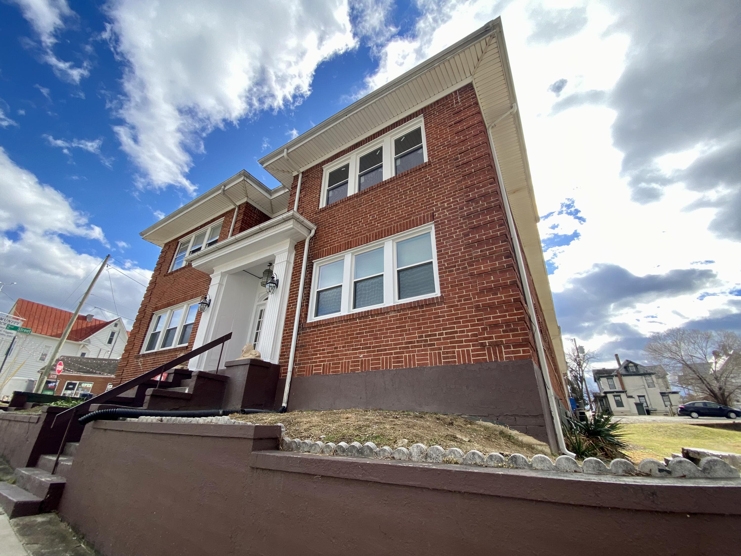 202 Elm Avenue, Unit A6 Roanoke, VA 24016 - Photo 3 of 19 a front view of a house with a yard