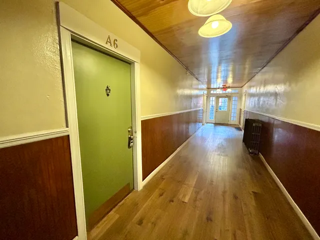 a view of gallery with wooden floor