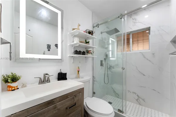 a bedroom with a bed a couch and a window