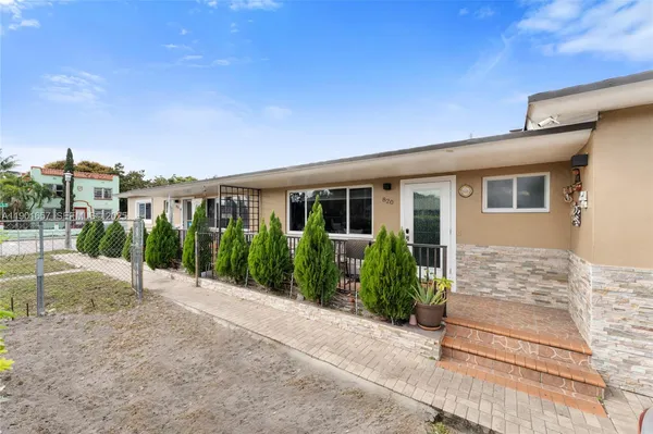a view of a house with backyard porch and sitting area