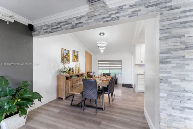 a dining room with furniture and wooden floor