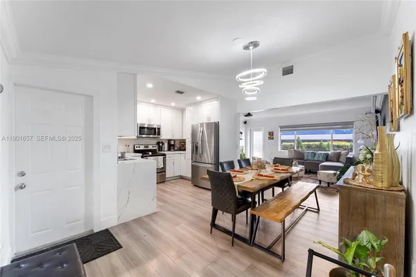 a kitchen with a refrigerator a sink and cabinets