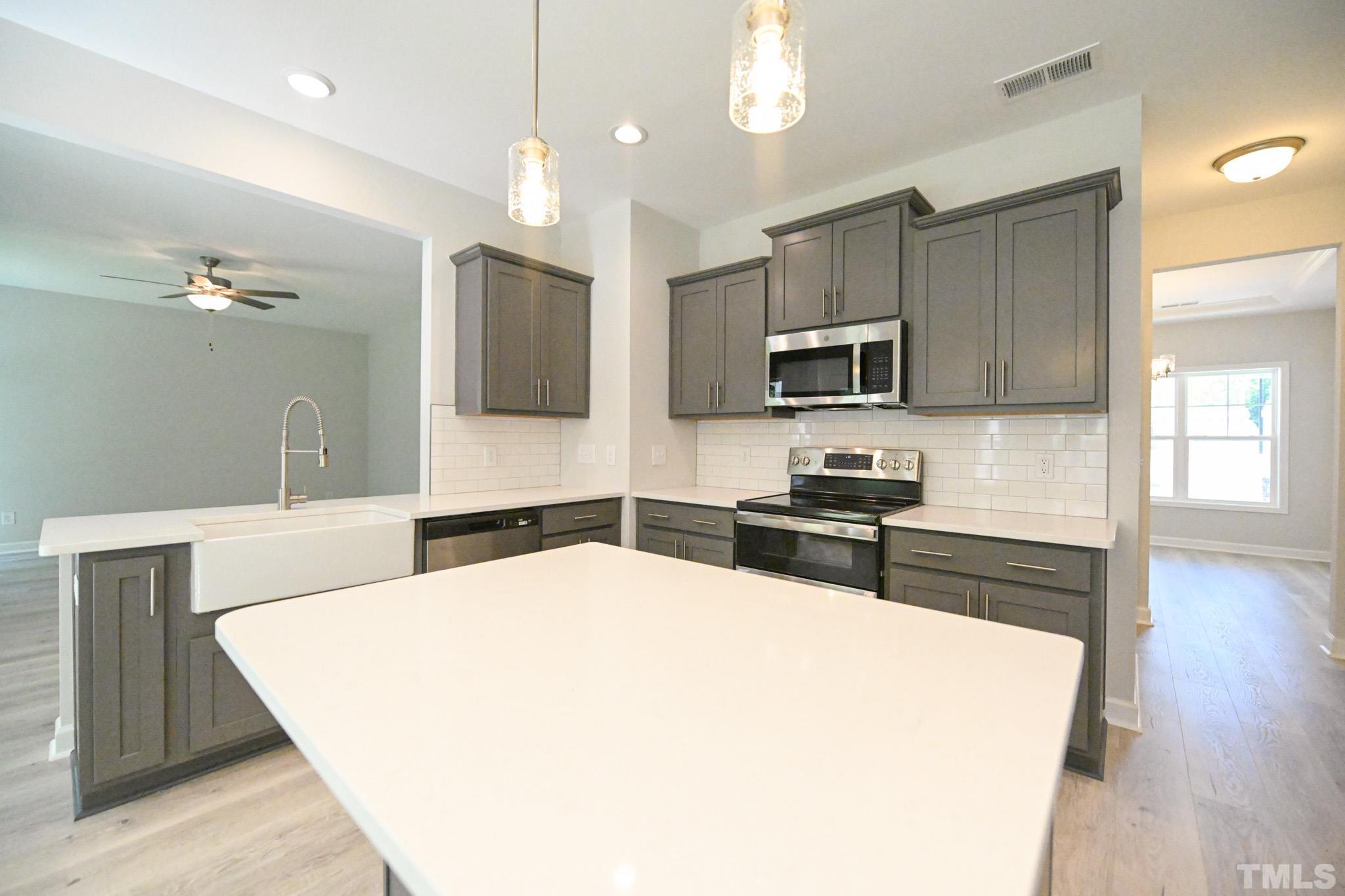 11 Kevin Troy Court Angier, NC 27501 - Photo 12 of 35 a kitchen with kitchen island a counter space a sink appliances and cabinets