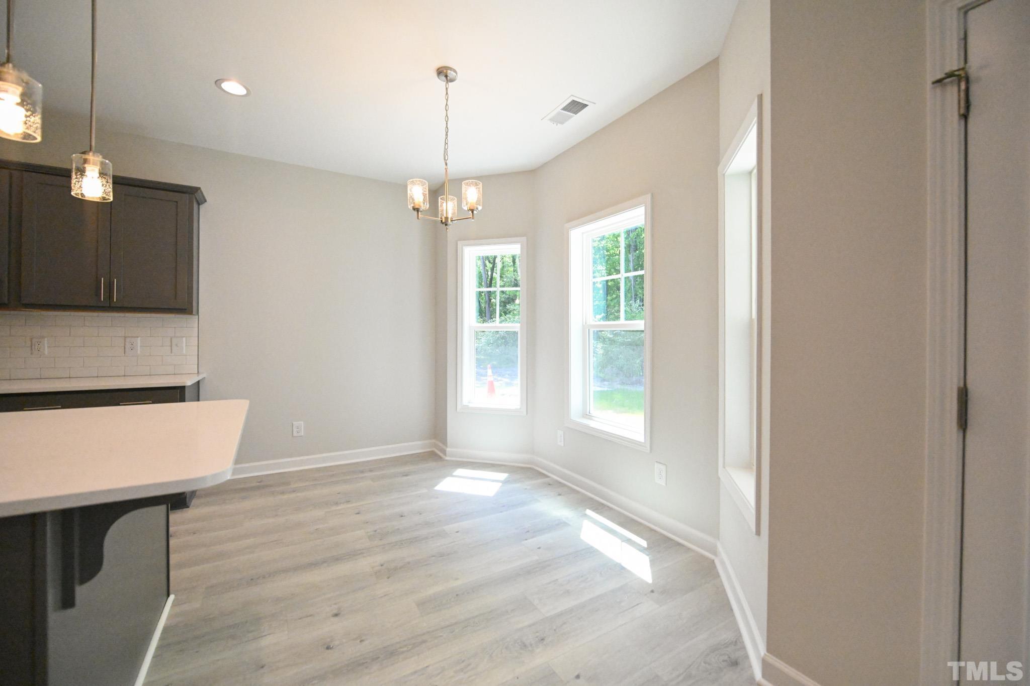11 Kevin Troy Court Angier, NC 27501 - Photo 15 of 35 a view of an empty room with wooden floor and a window