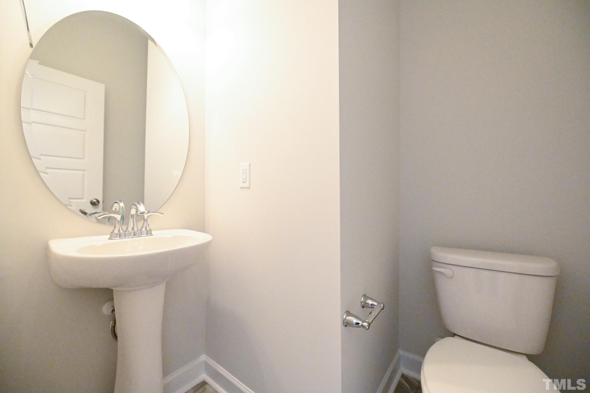 11 Kevin Troy Court Angier, NC 27501 - Photo 18 of 35 a bathroom with a toilet a sink and mirror
