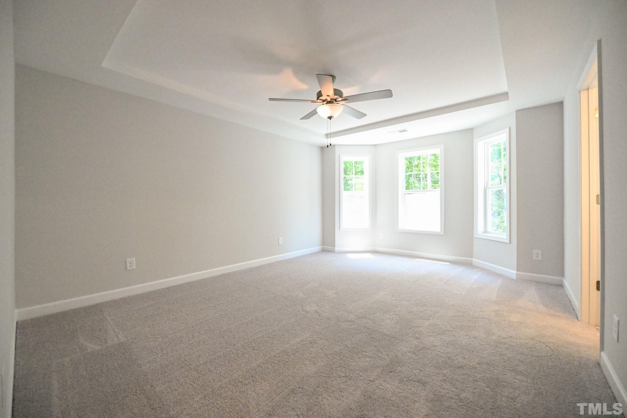 11 Kevin Troy Court Angier, NC 27501 - Photo 20 of 35 an empty room with windows and ceiling fan