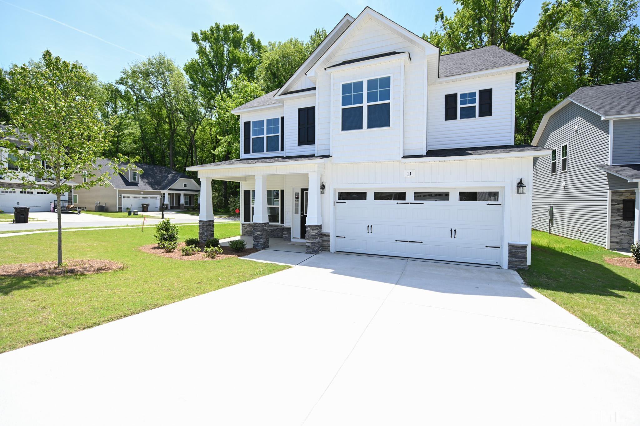 11 Kevin Troy Court Angier, NC 27501 - Photo 2 of 35 a front view of a house with a yard and trees