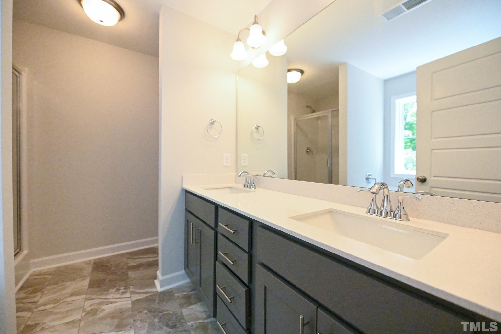 11 Kevin Troy Court Angier, NC 27501 - Photo 22 of 35 a bathroom with a sink vanity and a mirror