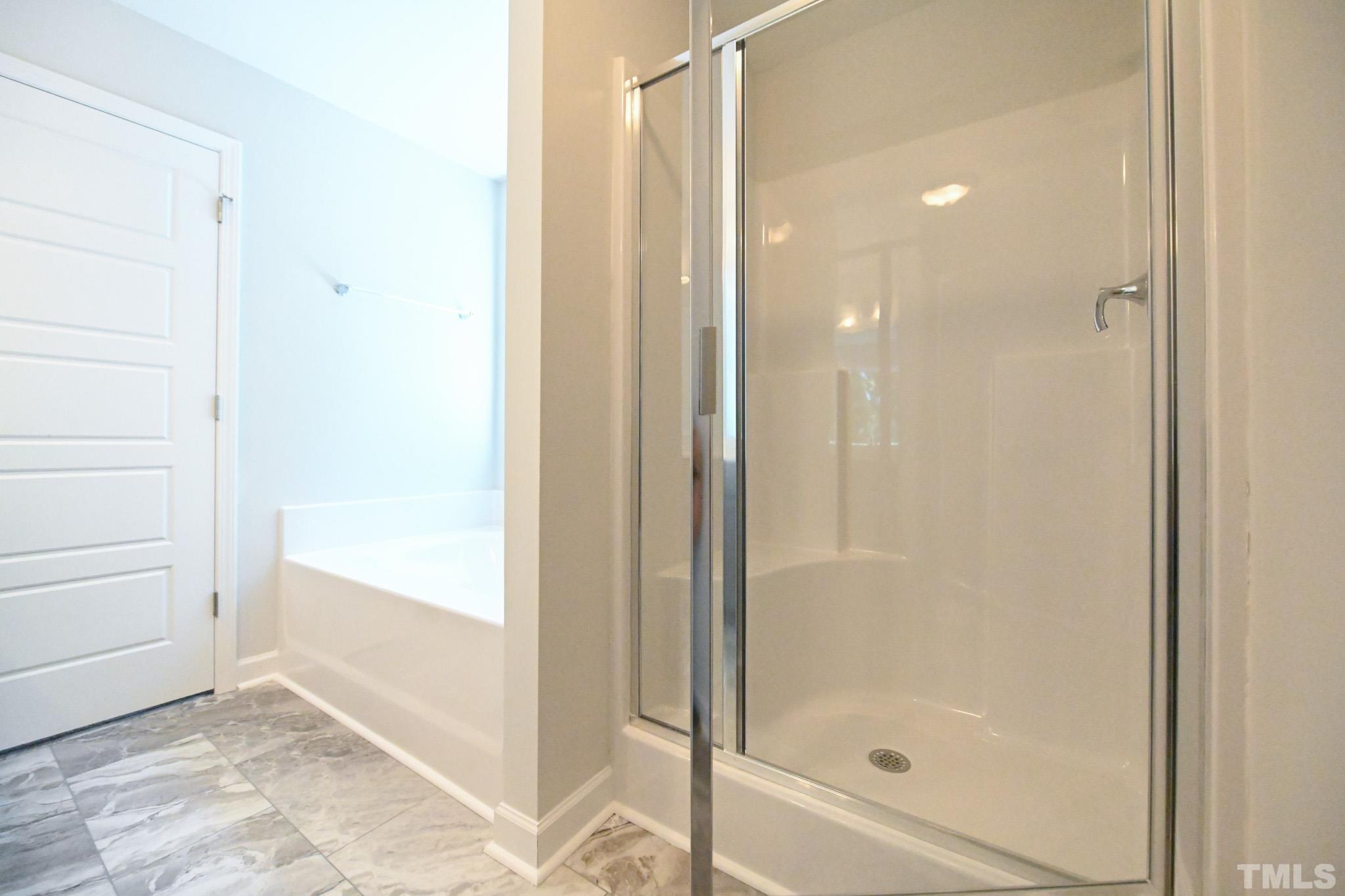 11 Kevin Troy Court Angier, NC 27501 - Photo 24 of 35 a bathroom with a glass shower door