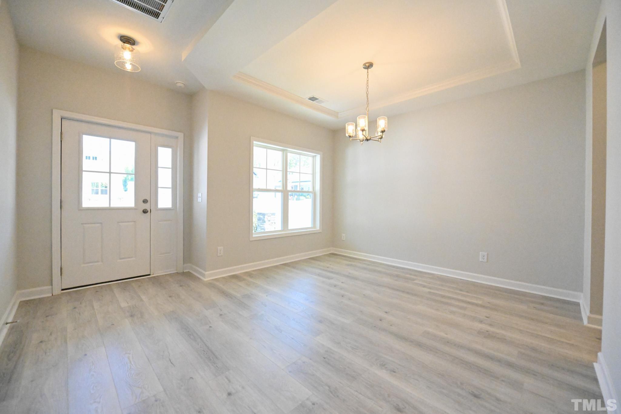 11 Kevin Troy Court Angier, NC 27501 - Photo 4 of 35 an empty room with wooden floor and windows