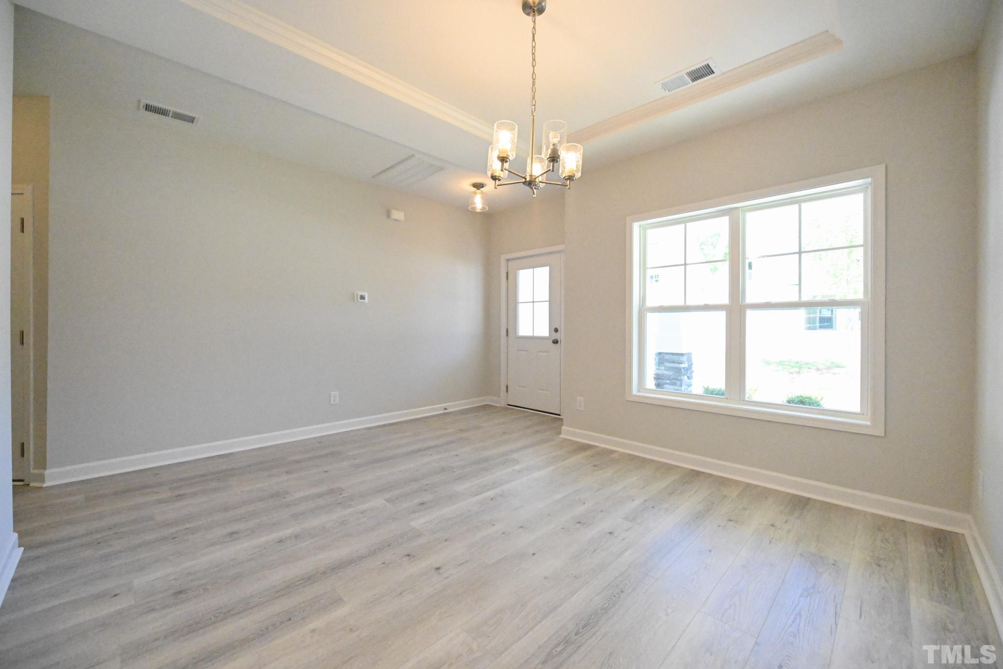 11 Kevin Troy Court Angier, NC 27501 - Photo 5 of 35 wooden floor in an empty room with a window
