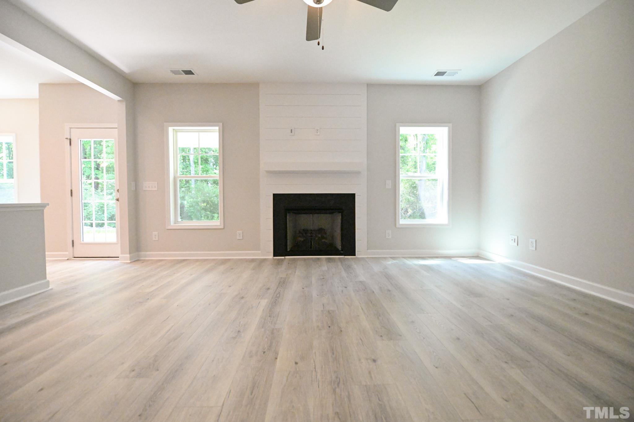 11 Kevin Troy Court Angier, NC 27501 - Photo 7 of 35 an empty room with windows and fireplace