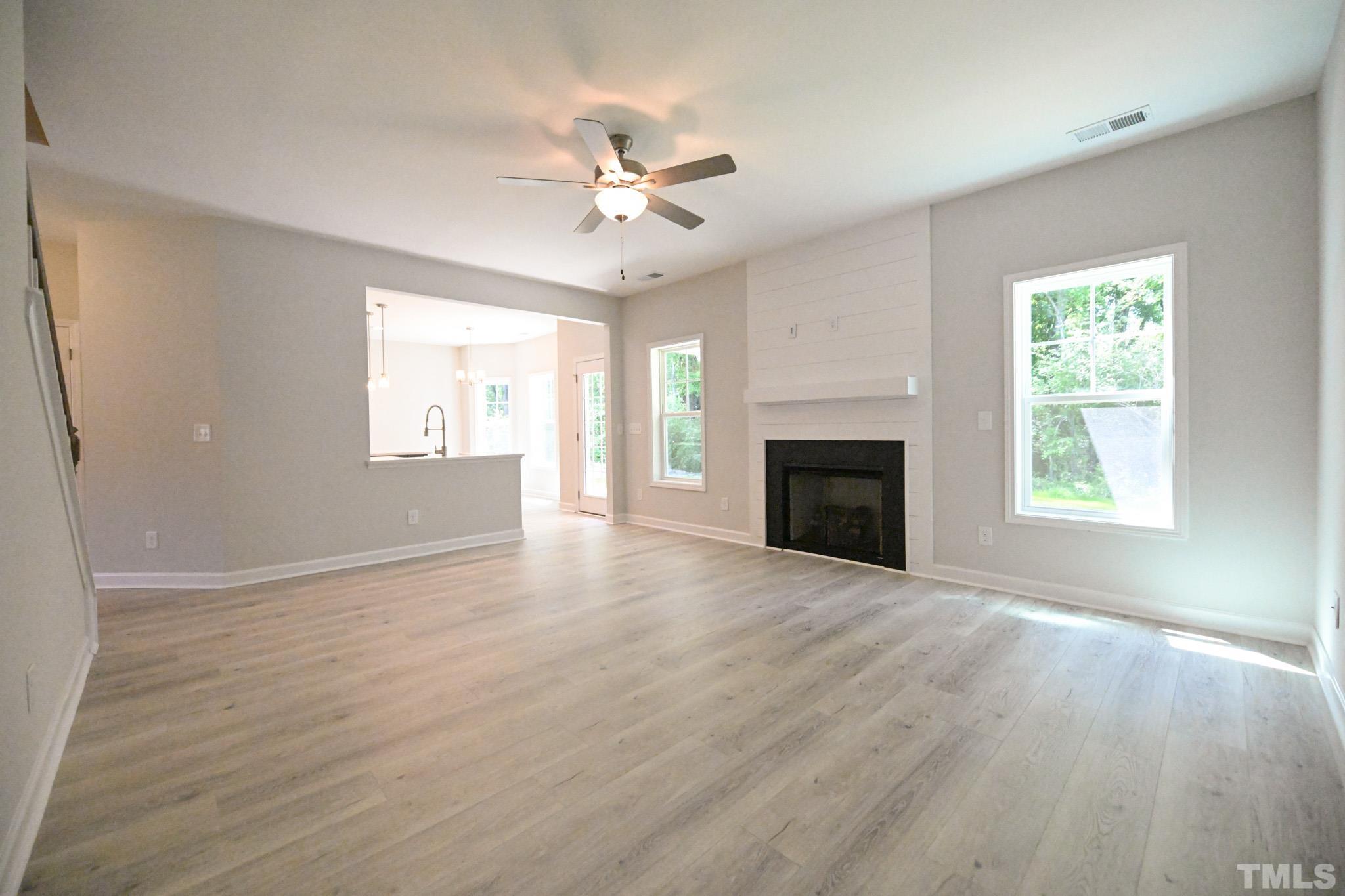 11 Kevin Troy Court Angier, NC 27501 - Photo 8 of 35 wooden floor fireplace and windows in an empty room