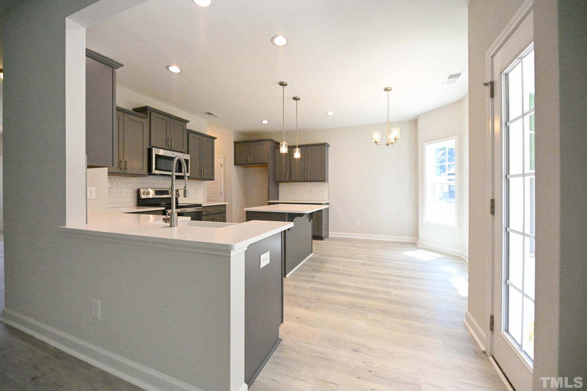 11 Kevin Troy Court Angier, NC 27501 - Photo 10 of 35 a kitchen with kitchen island a sink stainless steel appliances and cabinets