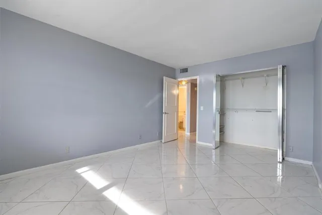 a view of an empty room and fire place