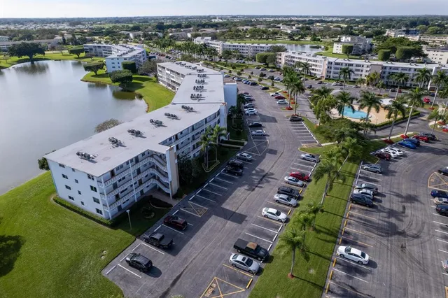 an aerial view of a house with outdoor space and lake view
