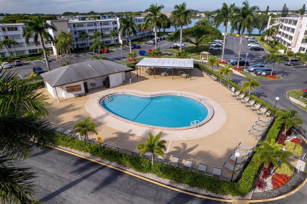 4036 Cornwall East, Unit 4036 Boca Raton, FL 33434 - Photo 30 of 30 an aerial view of a swimming pool with a yard and outdoor seating