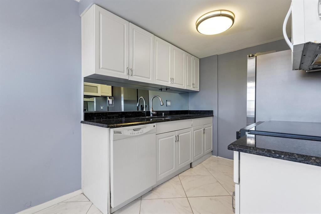 4036 Cornwall East, Unit 4036 Boca Raton, FL 33434 - Photo 4 of 30 a kitchen with stainless steel appliances granite countertop a sink and a stove