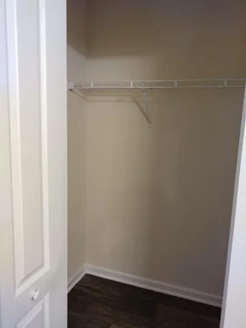 a view of a tennis ground with large trees