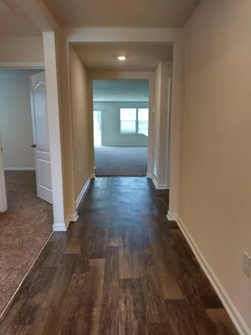 a large kitchen with a large counter top a sink stainless steel appliances and cabinets