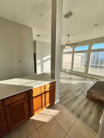 a spacious bathroom with a granite countertop sink and a mirror