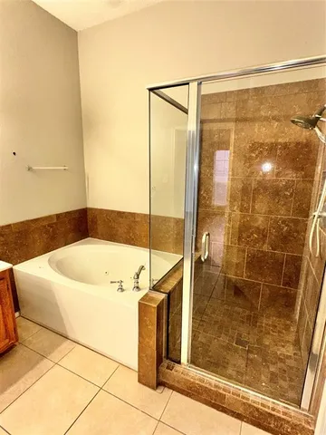 a bathroom with a bathtub and shower