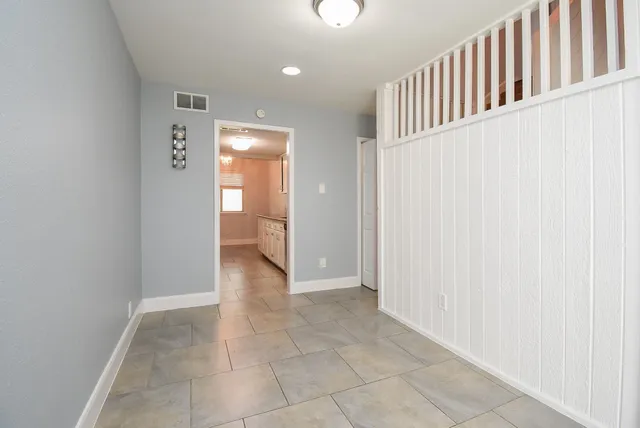 a kitchen with granite countertop a sink stainless steel appliances and white cabinets
