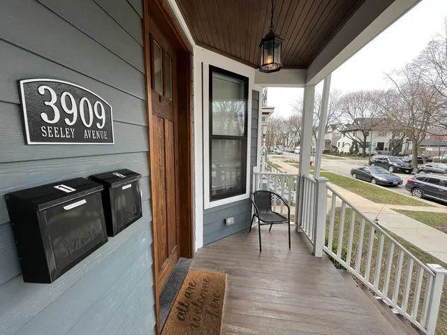a view of a hallway with wooden floor and furniture