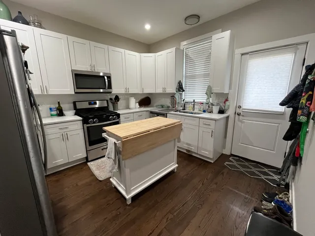 a kitchen with a sink appliances and cabinets